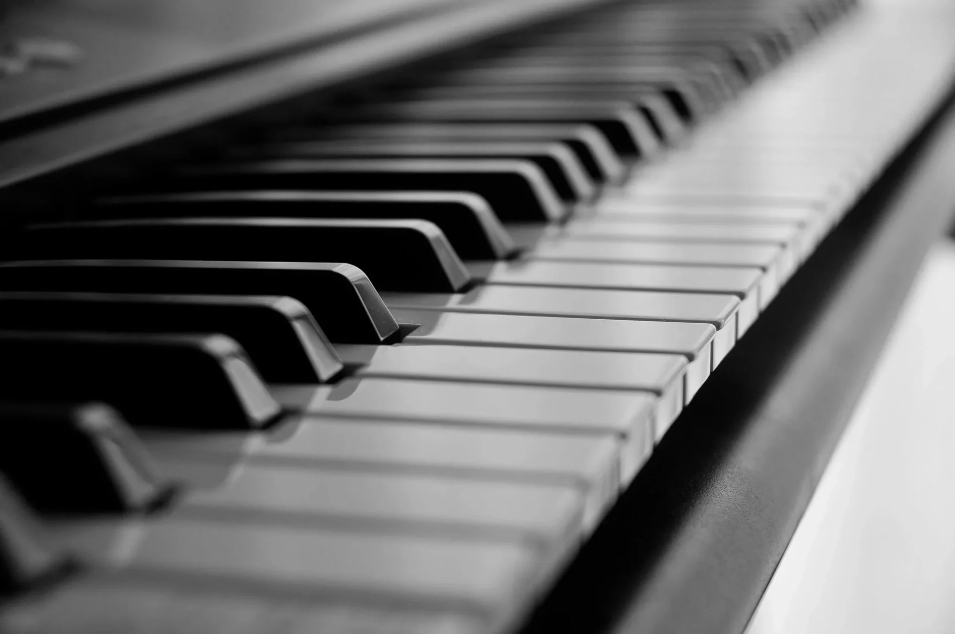 A close up of the keys on an old piano